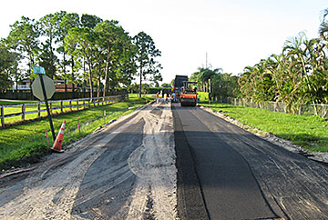 Asphalt paving equipment paving roadway in South Indian River Water Control District